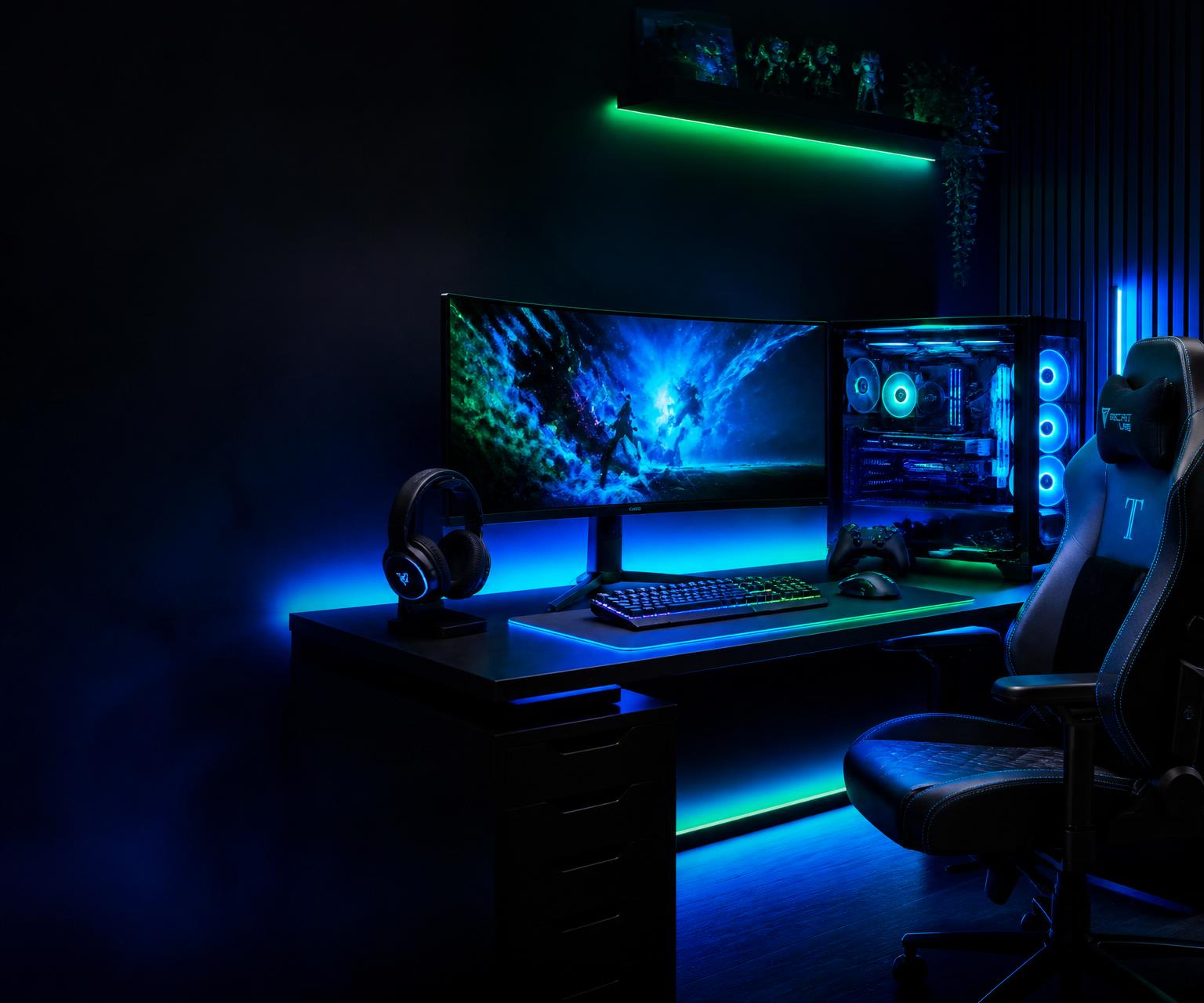 Premium gaming setup with RGB gaming PC, ultrawide OLED monitor, mechanical keyboard, gaming mouse, headset, controller, and premium gaming chair under ambient RGB lighting